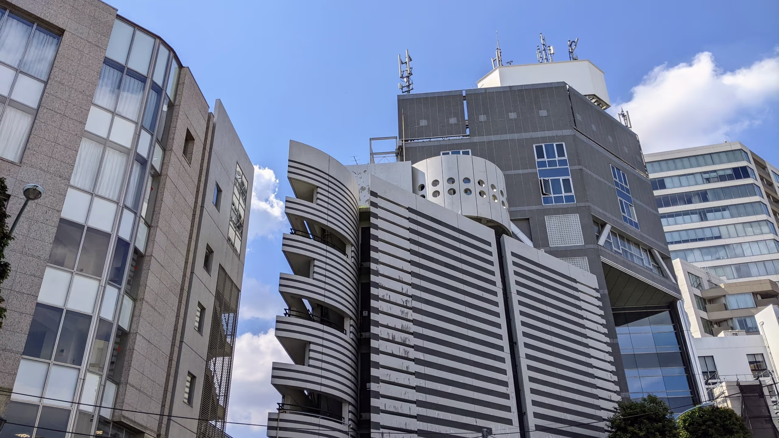 三角系の建物の上に丸い部屋が乗っかり、端には特徴的な非常階段が組み合わされている